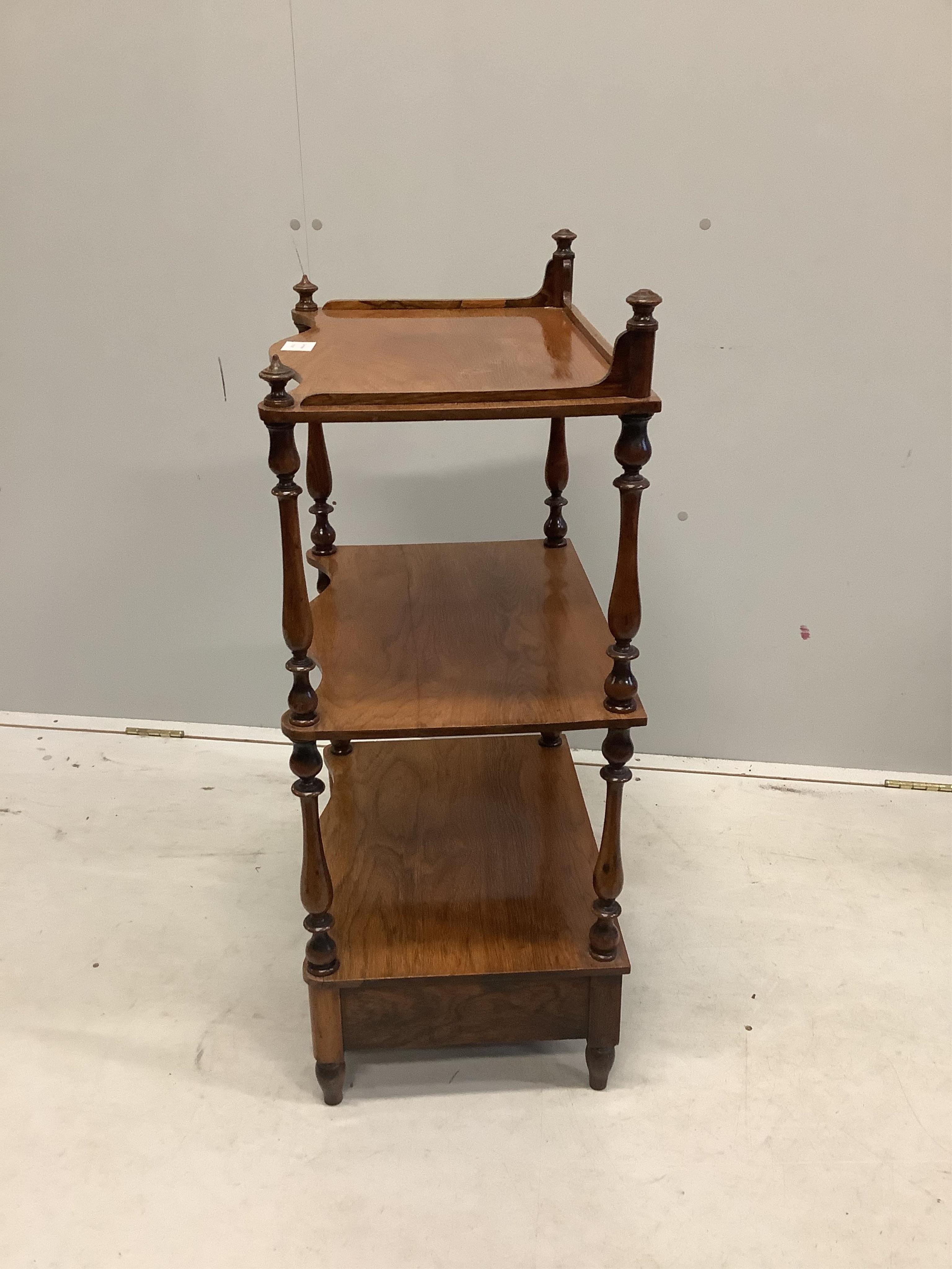 An early Victorian rosewood serpentine front three tier whatnot, width 50cm, depth 35cm, height 92cm. Condition - fair to good